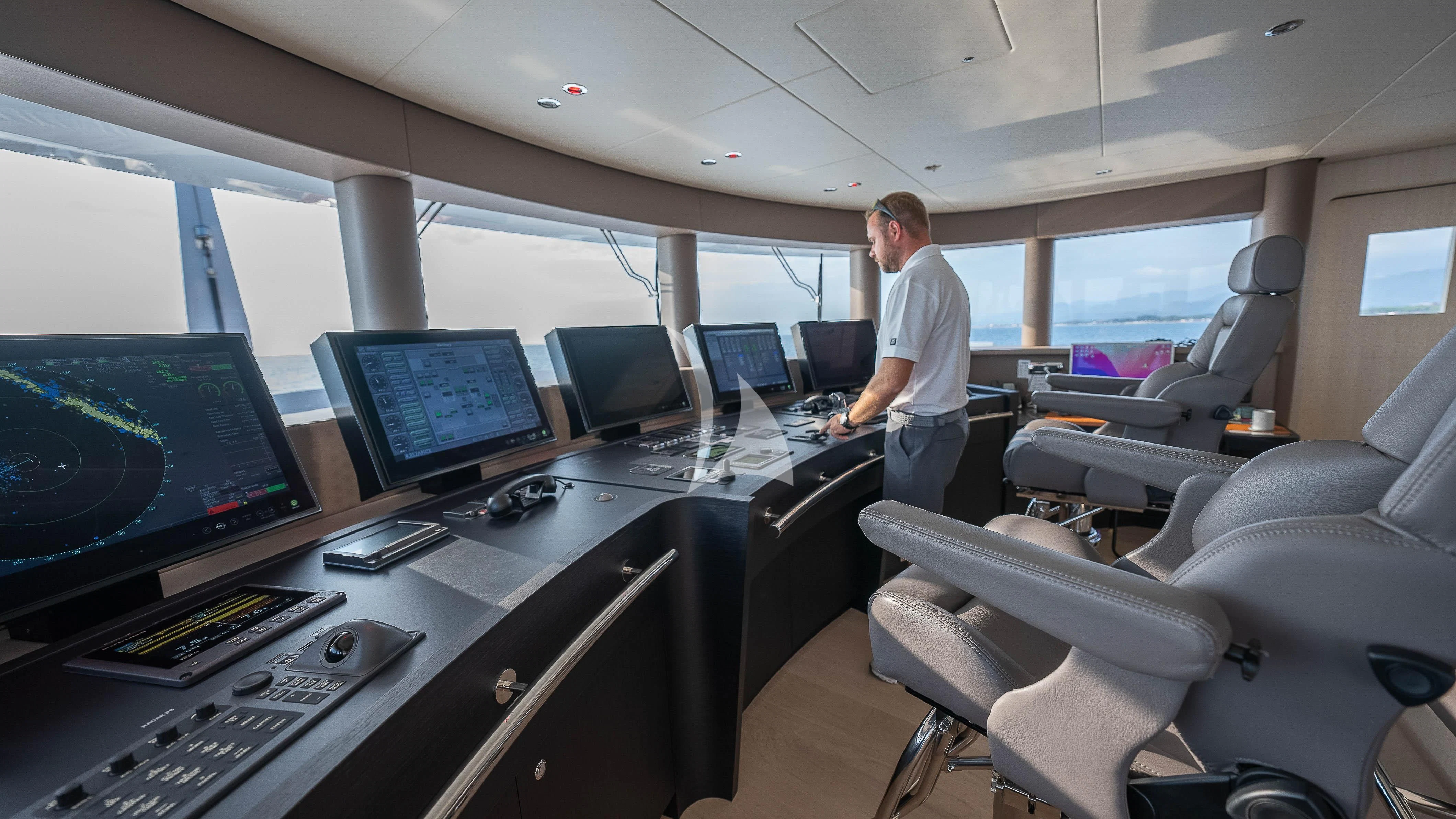 a person standing in front of a computer aboard RELIANCE Yacht for Sale