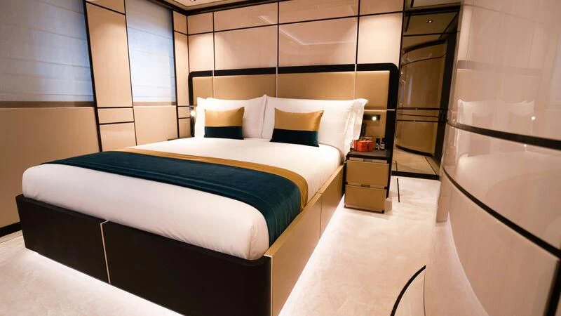 a room with a bed and a desk aboard RELIANCE Yacht for Sale