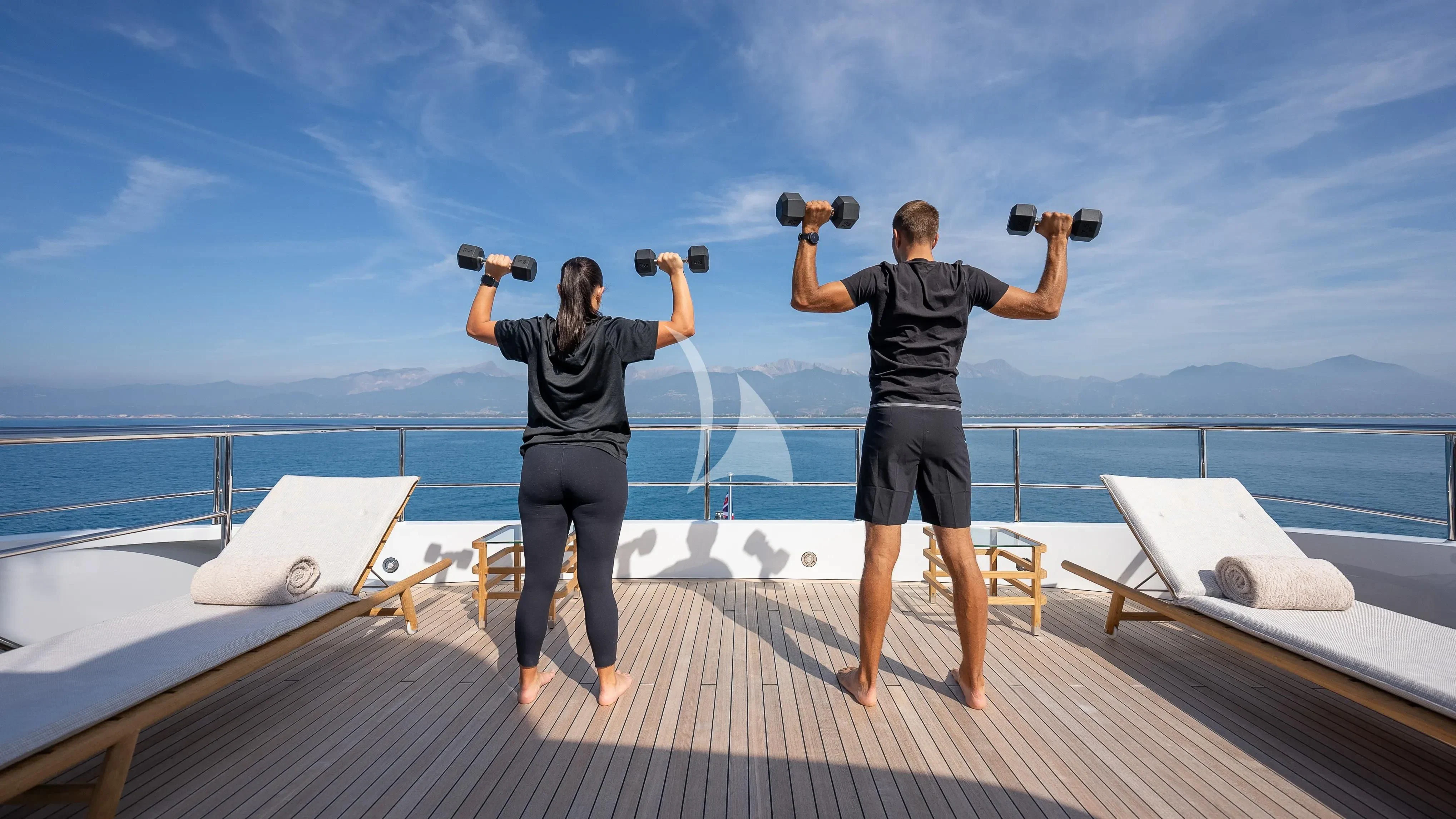 two people standing on a deck overlooking the ocean aboard RELIANCE Yacht for Sale