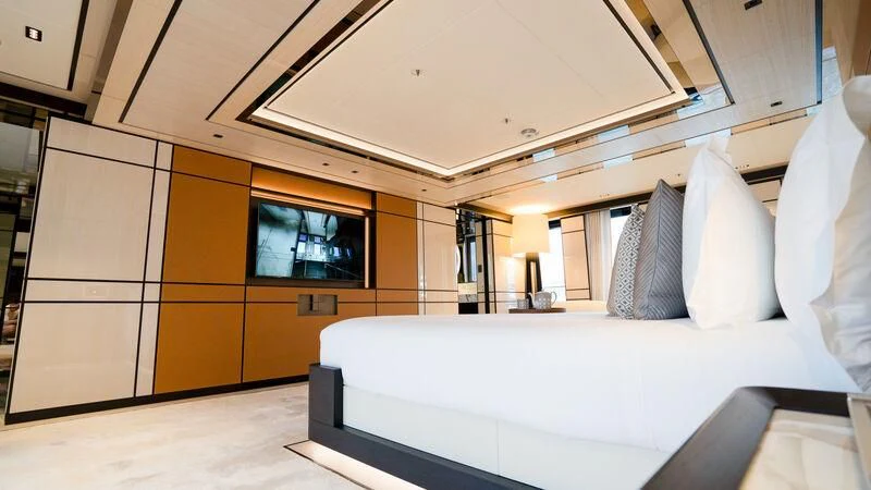 a room with a bed and a desk aboard RELIANCE Yacht for Sale