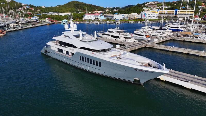 a large white boat in a harbor aboard RELIANCE Yacht for Sale