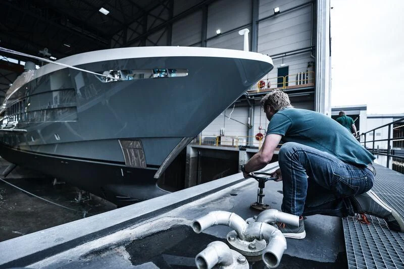 a person fixing a car aboard RELIANCE Yacht for Sale