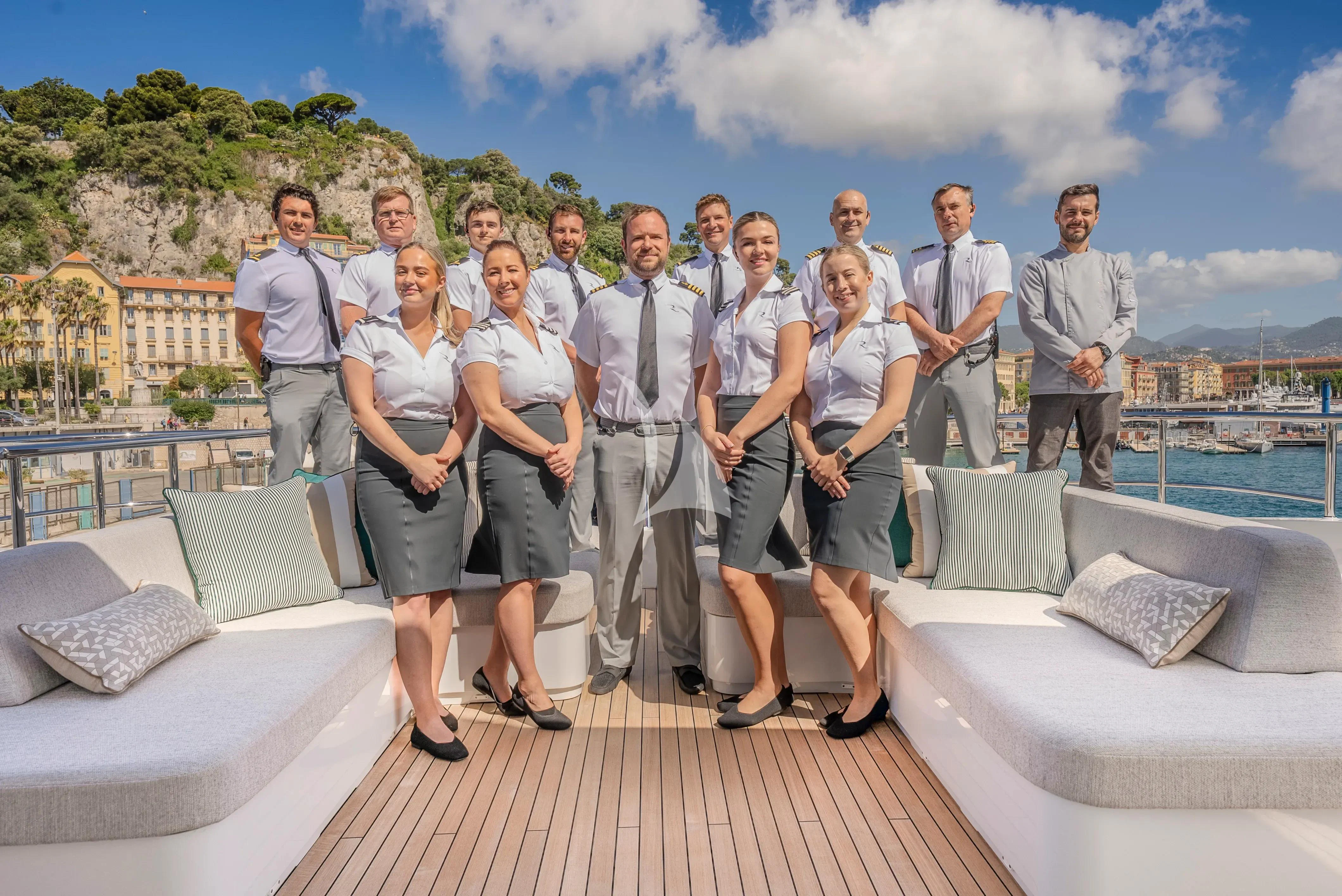 a group of people standing on a deck aboard RELIANCE Yacht for Sale