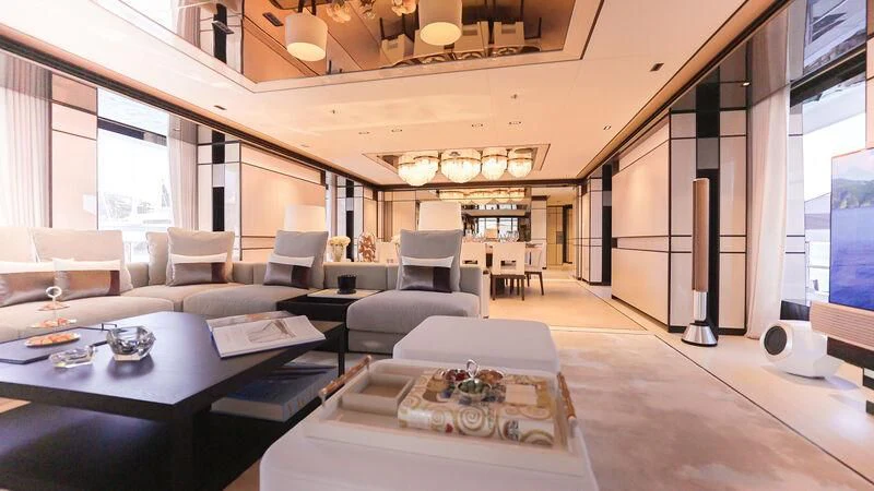 a room with a table chairs and a couch aboard RELIANCE Yacht for Sale