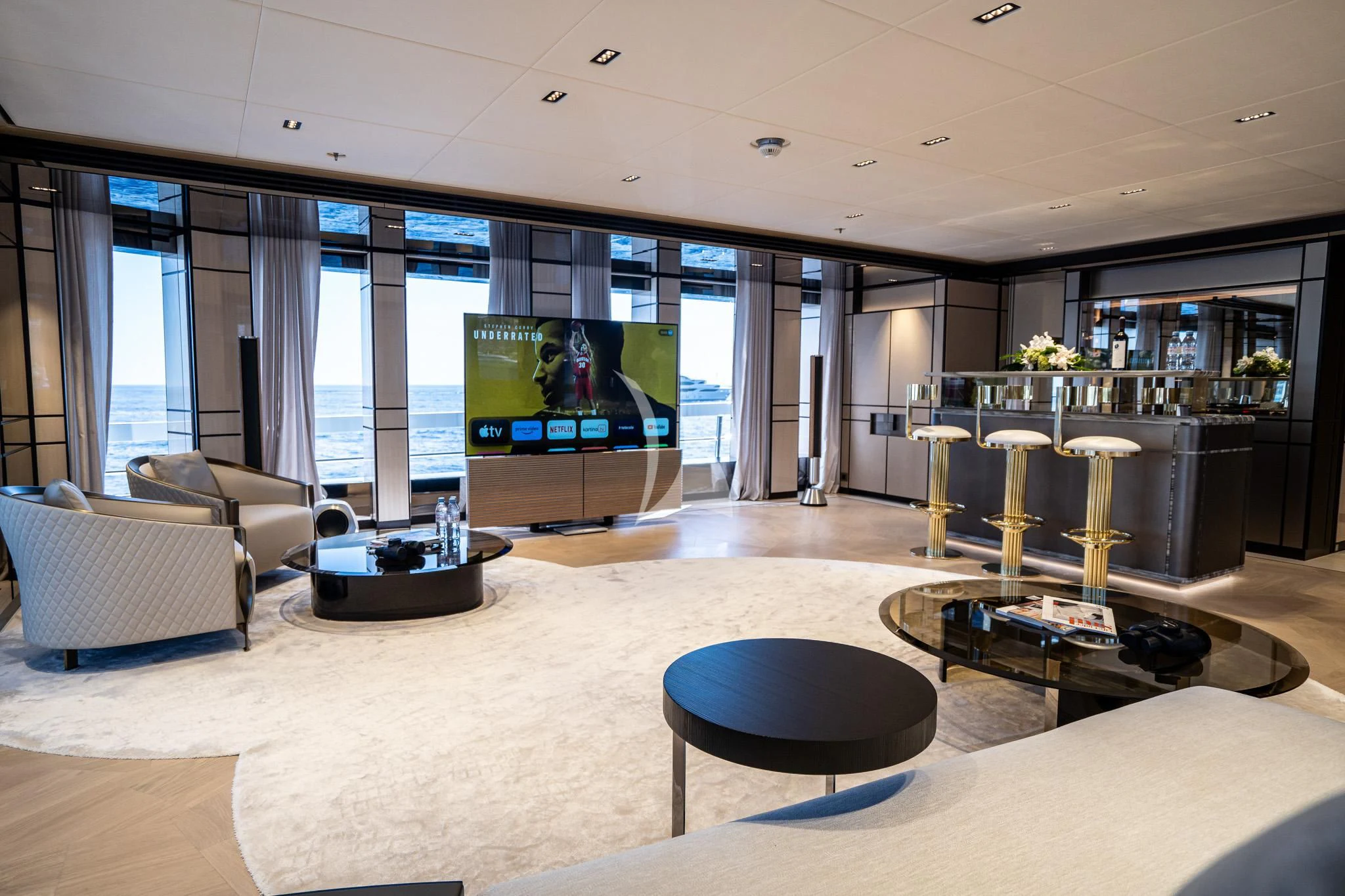 a room with a tv and couches aboard RELIANCE Yacht for Sale
