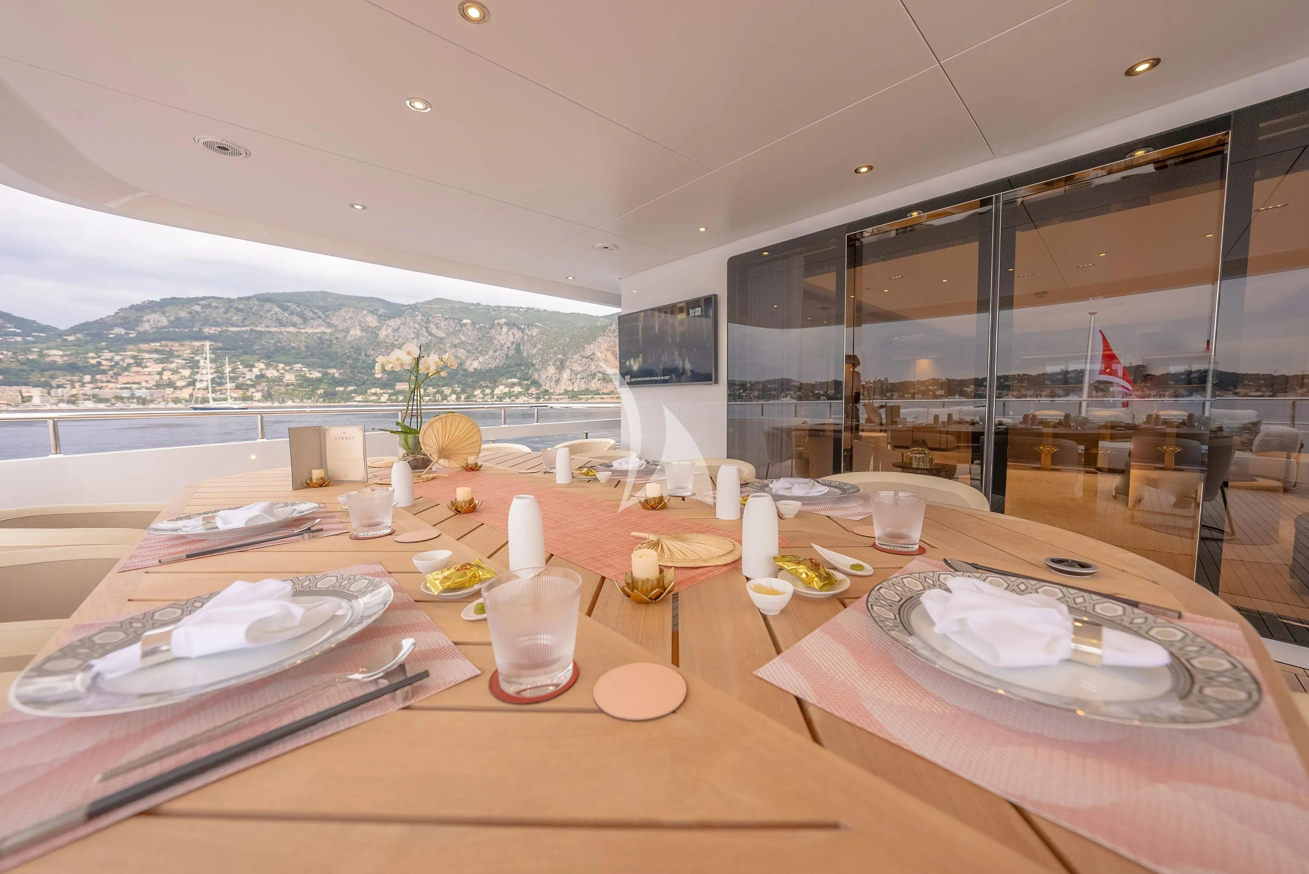 a table with plates and cups on it aboard RELIANCE Yacht for Sale