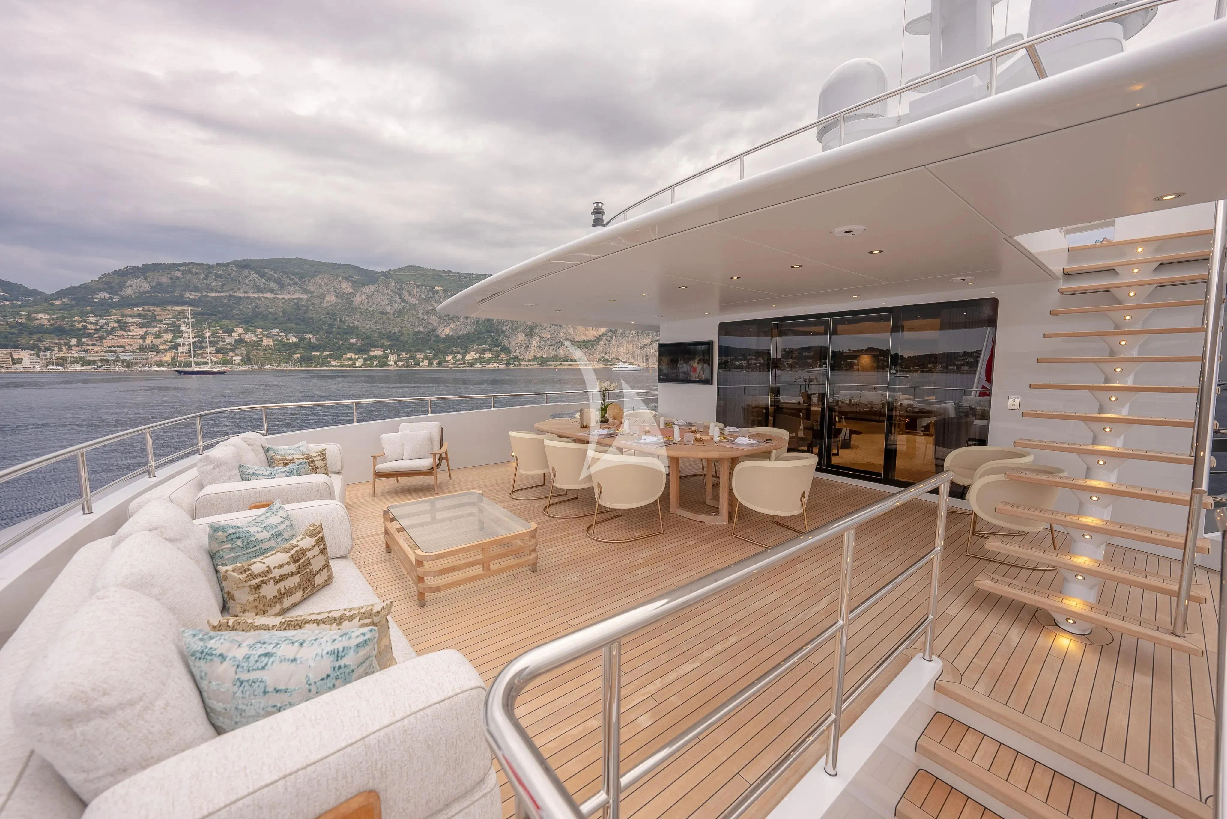 a balcony with a view of the ocean and mountains aboard RELIANCE Yacht for Sale