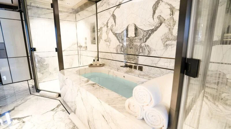 a bathroom with a large rock wall aboard RELIANCE Yacht for Sale