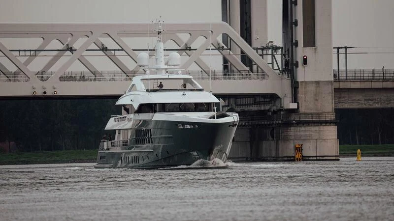 a large white boat in a body of water aboard RELIANCE Yacht for Sale