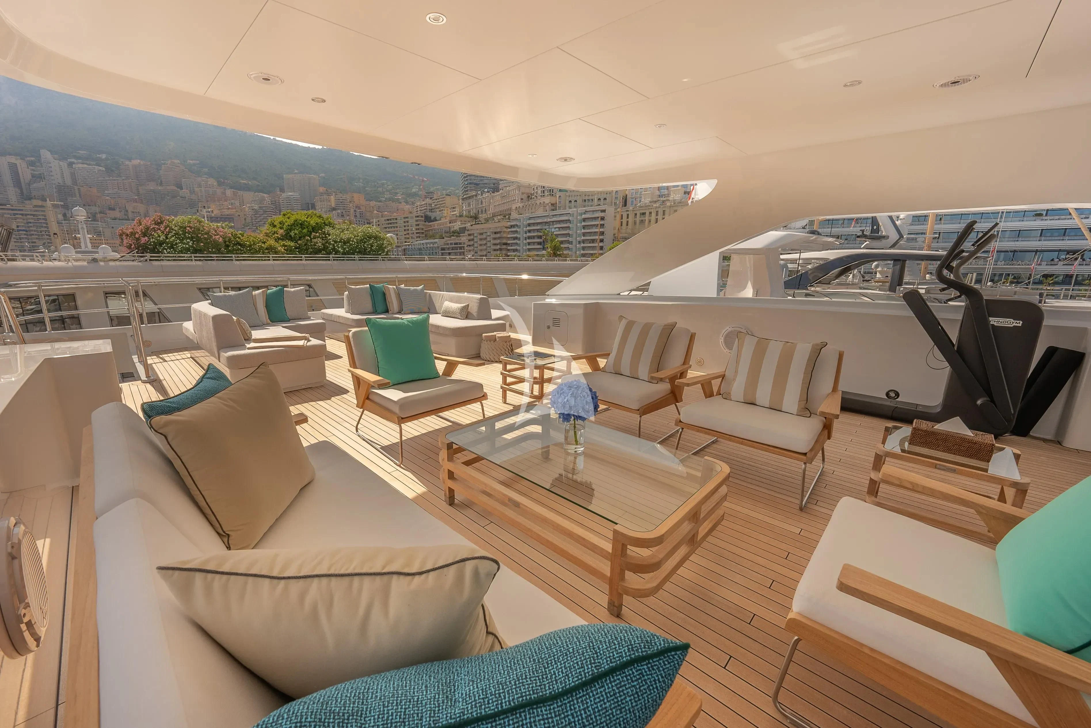 a room with a table chairs and a view of the city aboard RELIANCE Yacht for Sale