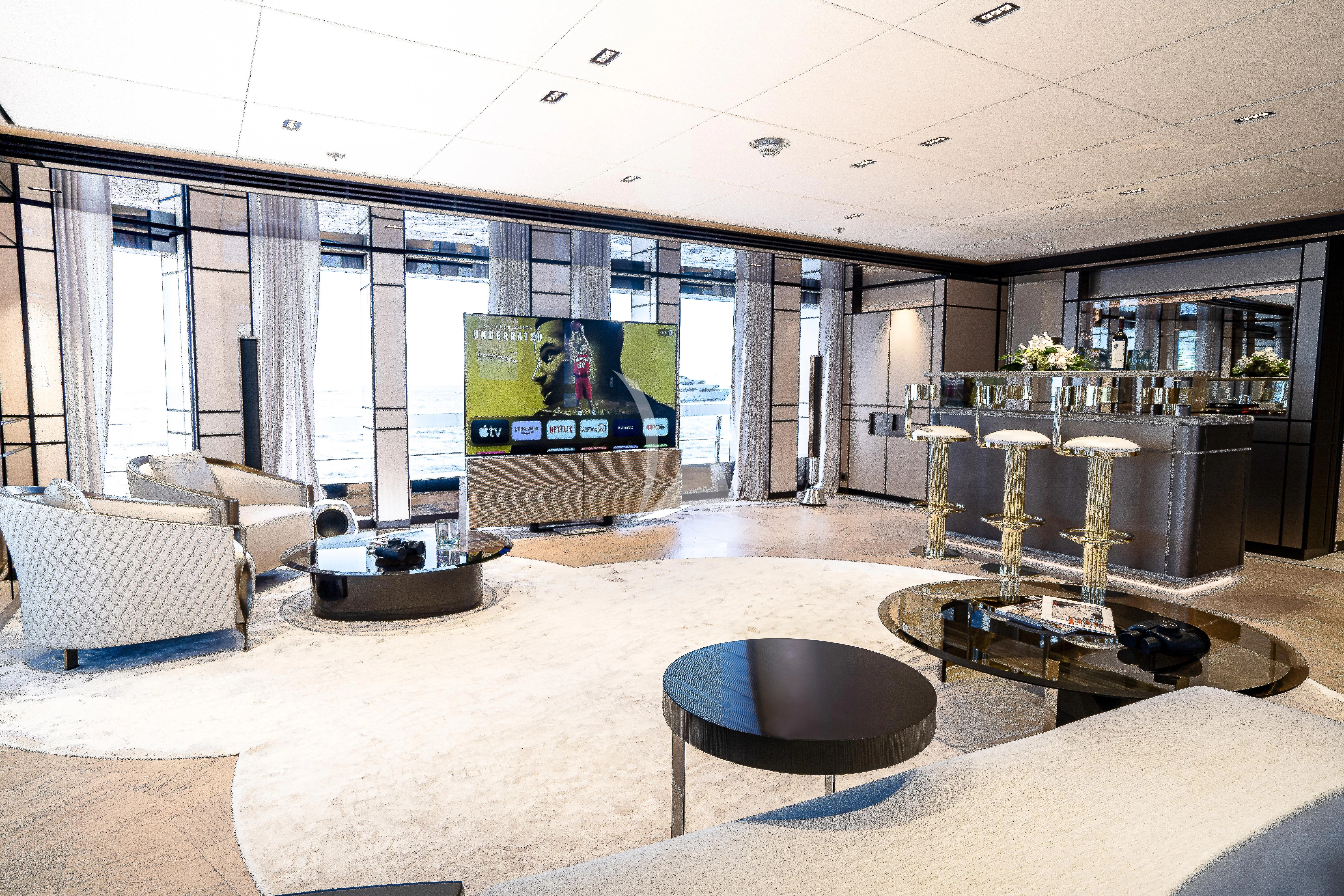 a room with a tv and chairs aboard RELIANCE Yacht for Sale