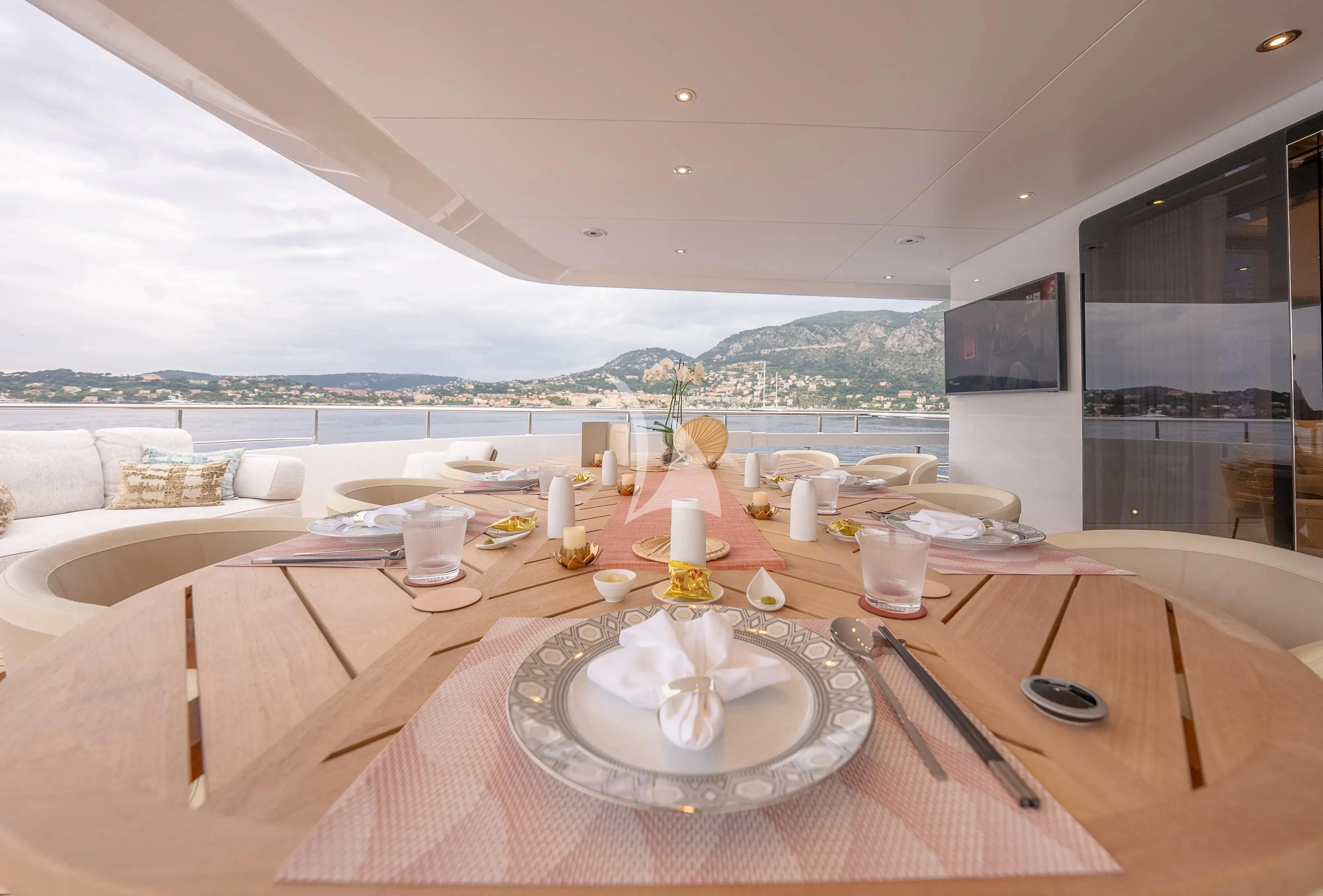 a table with plates and food on it aboard RELIANCE Yacht for Sale