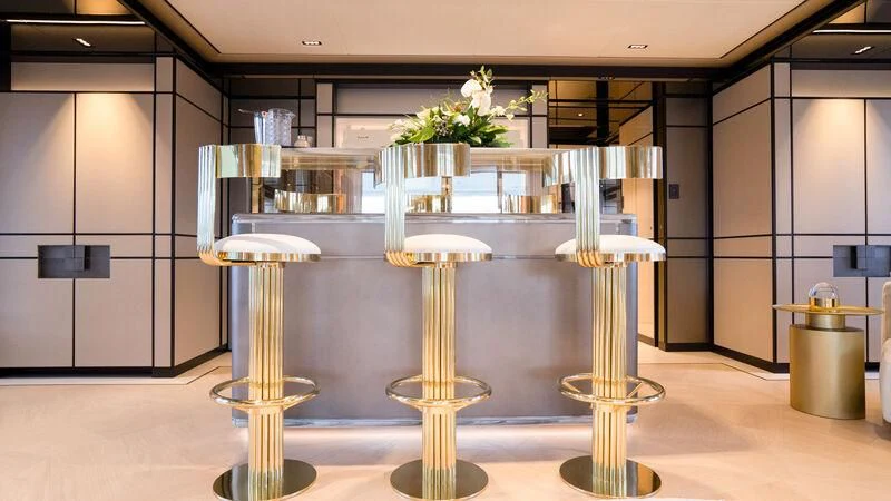 a few glass tables with white flowers aboard RELIANCE Yacht for Sale