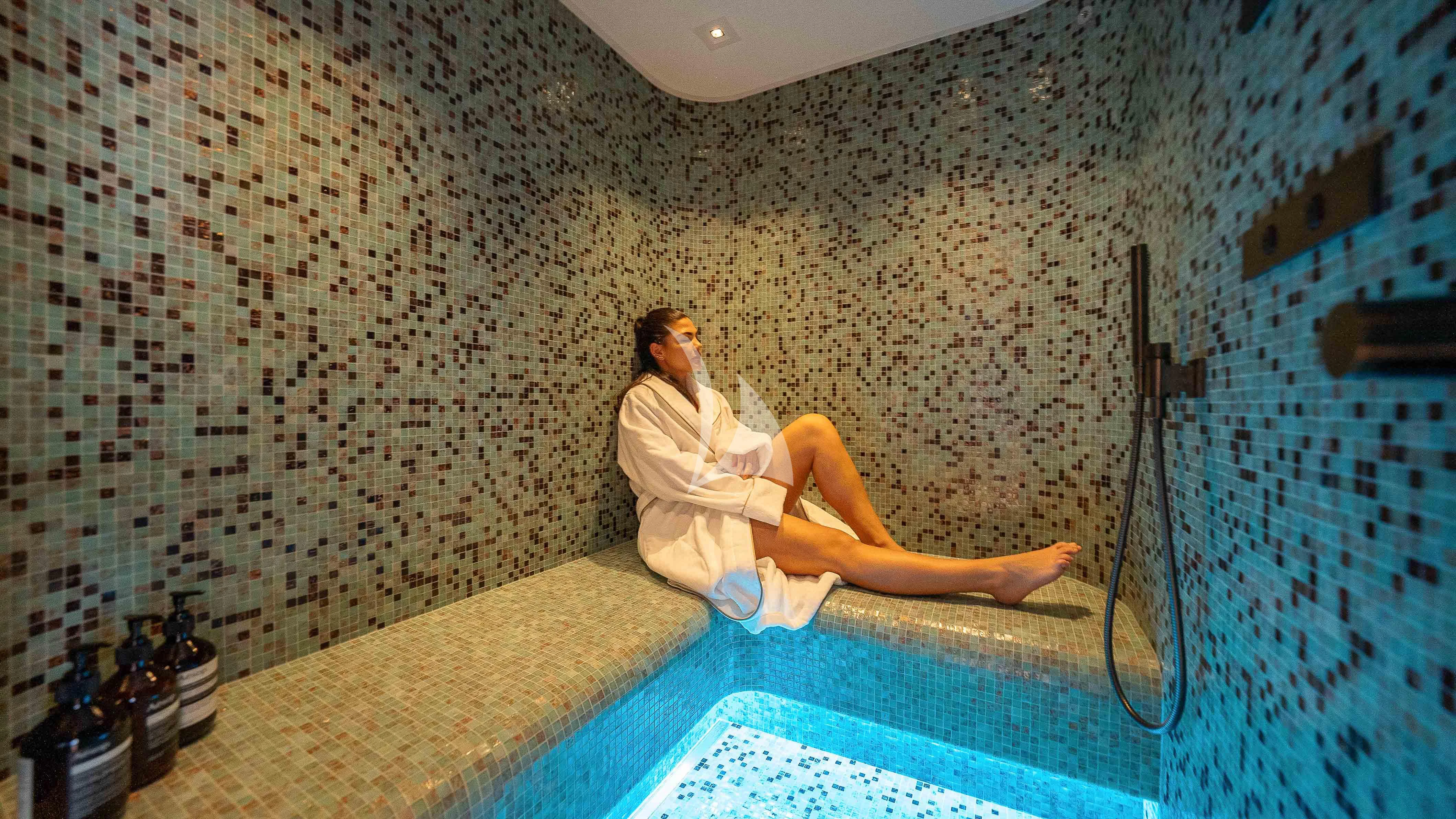 a person sitting on a mat in a bathroom aboard RELIANCE Yacht for Sale