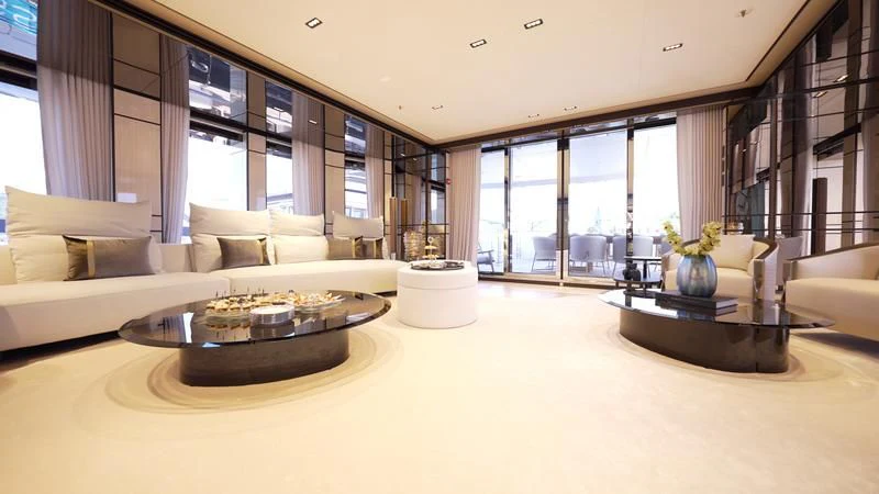 a living room with a table and couches aboard RELIANCE Yacht for Sale