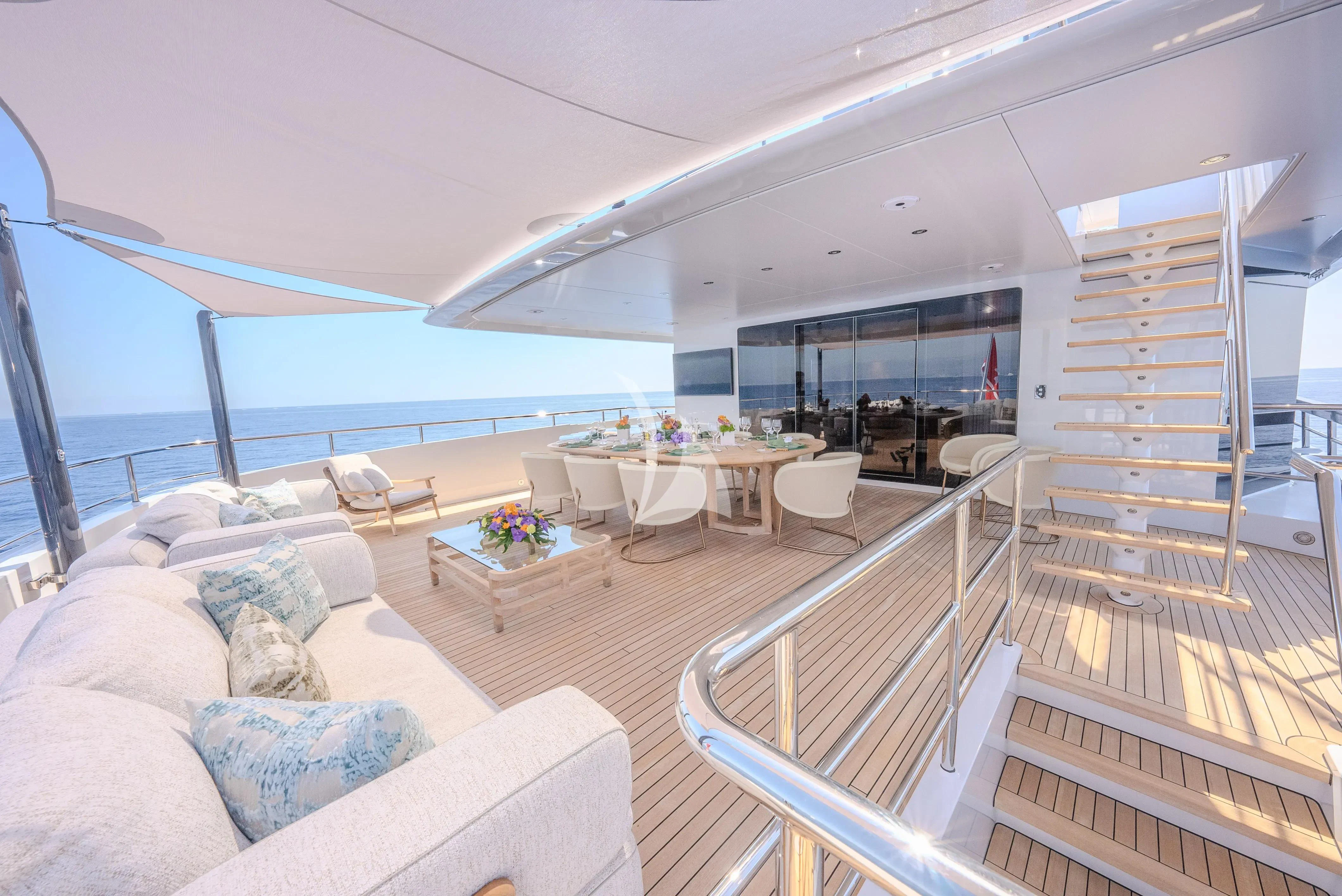 a living room with a large balcony aboard RELIANCE Yacht for Sale