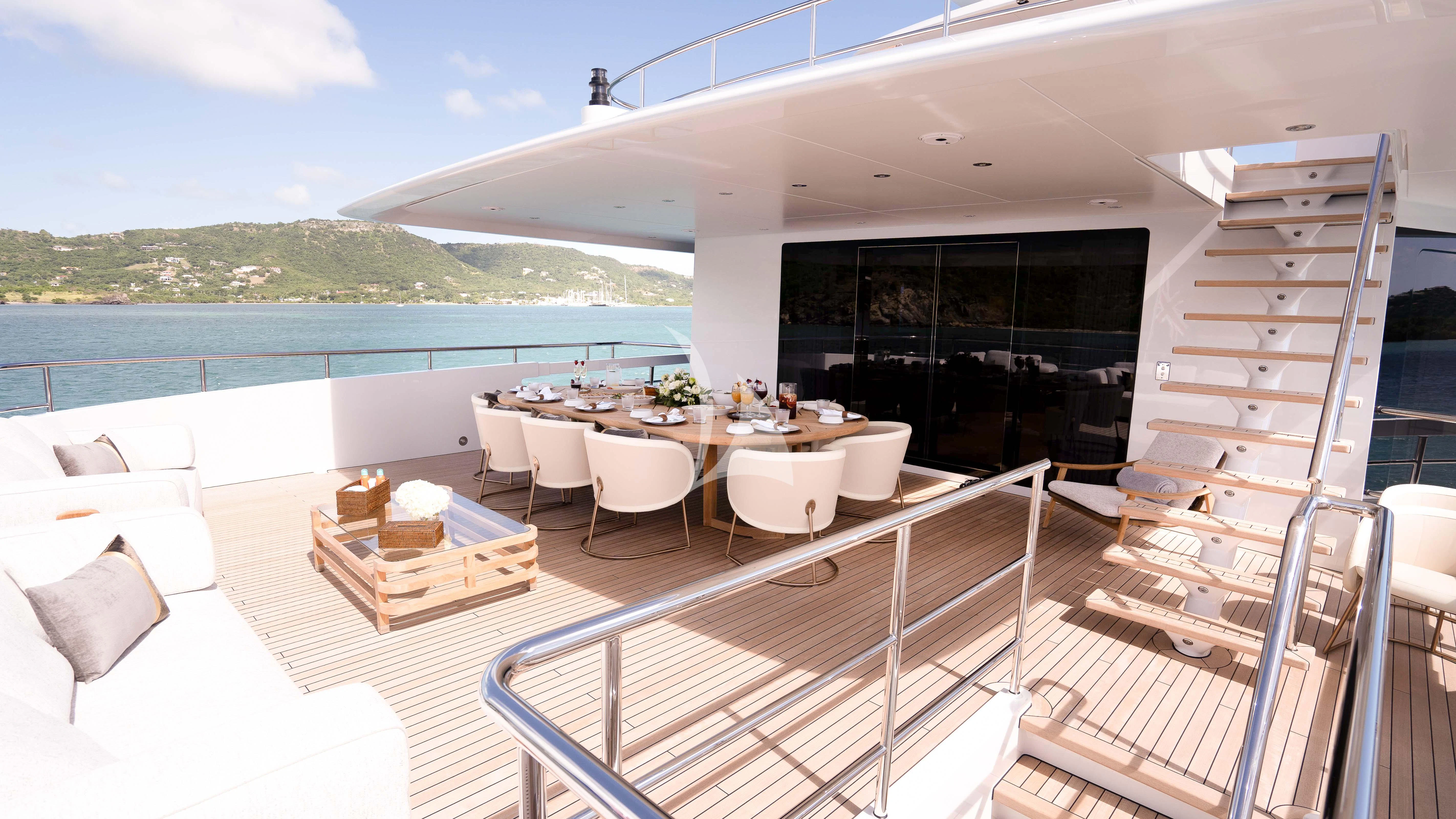a balcony with a table and chairs aboard RELIANCE Yacht for Sale