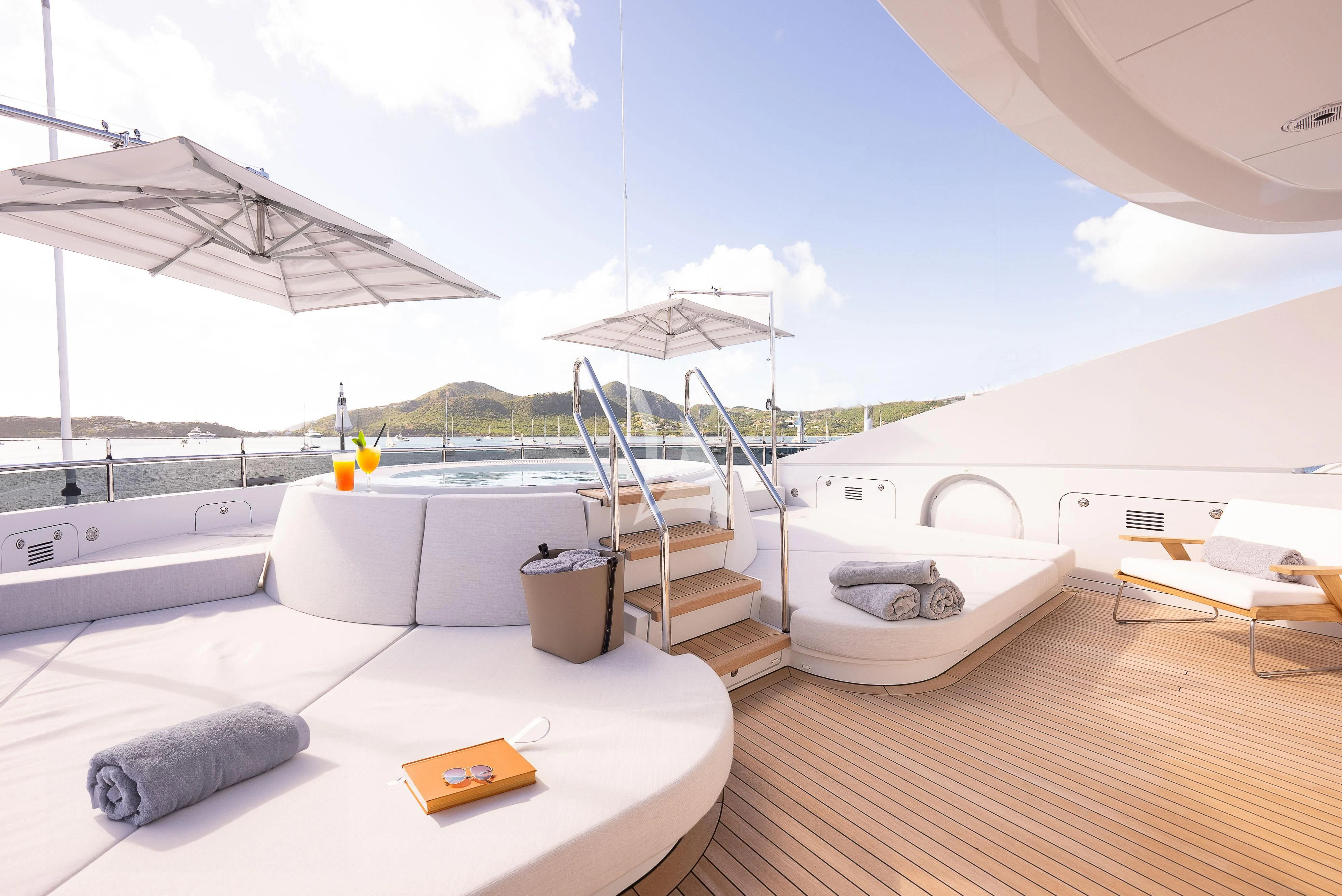 a room with a large deck and a pool aboard RELIANCE Yacht for Sale