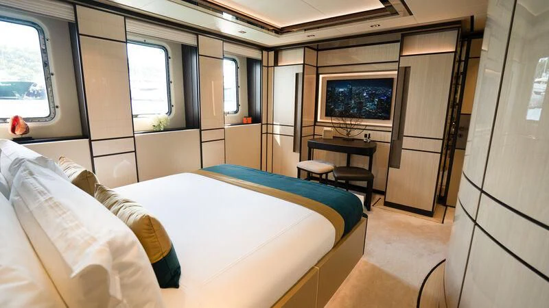 a bedroom with a bed and a tv aboard RELIANCE Yacht for Sale
