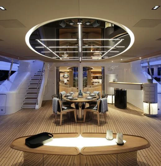 a large room with a table and chairs aboard SEVEN Yacht for Sale