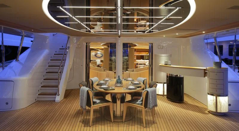 a room with a table and chairs aboard SEVEN Yacht for Sale