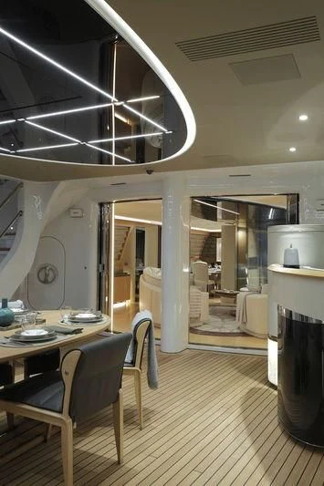 a room with a table and chairs aboard SEVEN Yacht for Sale