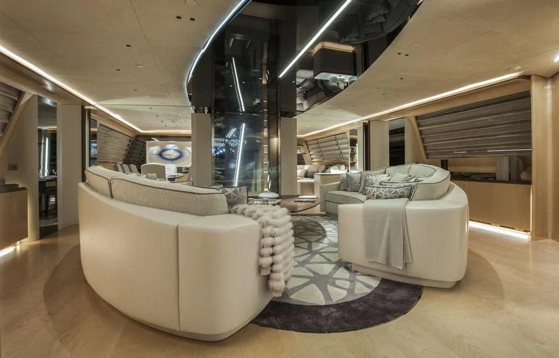 a room with a staircase and a large white couch aboard SEVEN Yacht for Sale