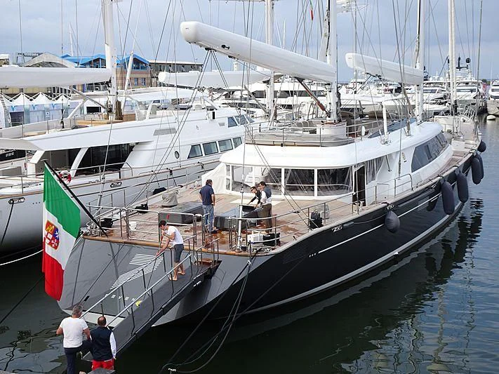 a group of people standing on a boat in a harbor aboard SEVEN Yacht for Sale
