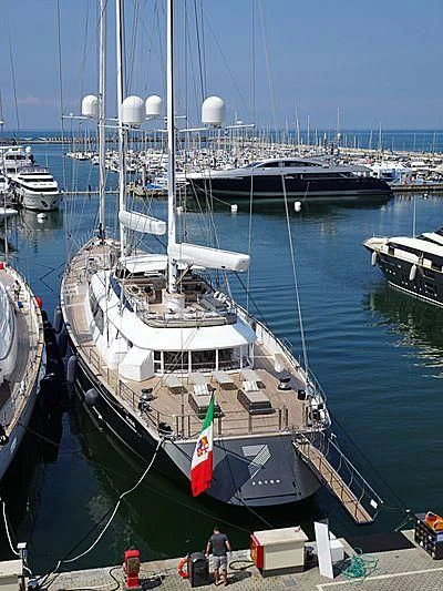 a large boat docked at a pier aboard SEVEN Yacht for Sale