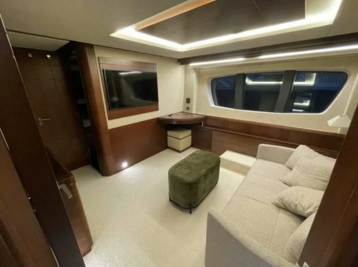 a room with a couch and a television aboard VIVERE Yacht for Sale
