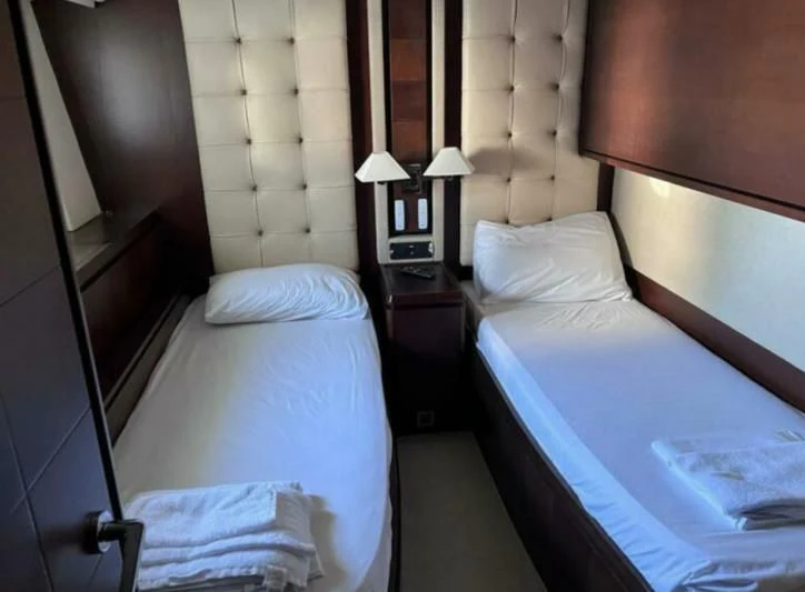 a couple of beds in a hotel room aboard VIVERE Yacht for Sale