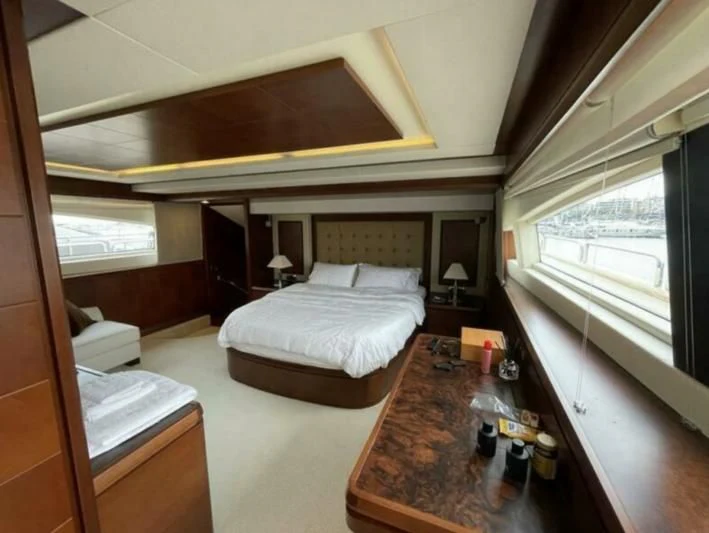 a room with a bed and a table aboard VIVERE Yacht for Sale