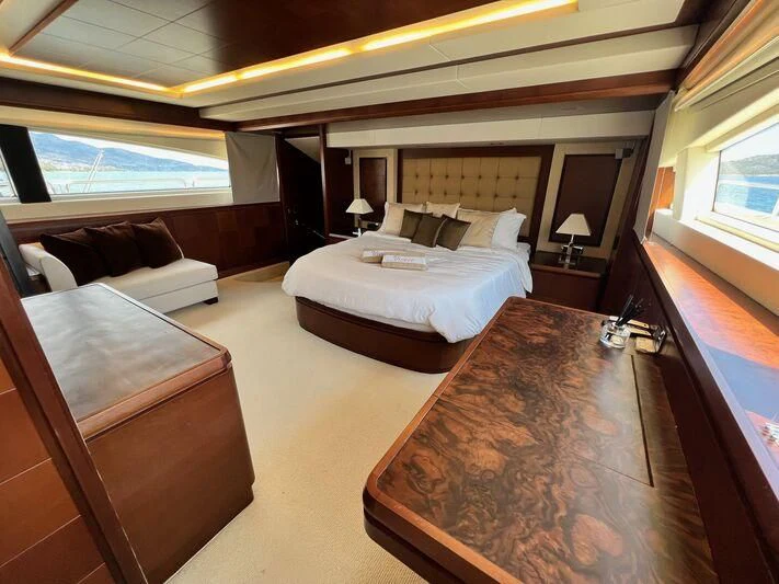 a hotel room with a bed and a couch aboard VIVERE Yacht for Sale