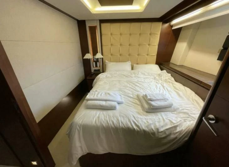 a bed with white sheets aboard VIVERE Yacht for Sale