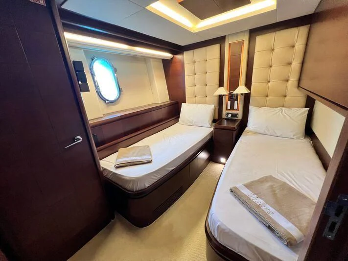 a hotel room with a bed and a mirror aboard VIVERE Yacht for Sale