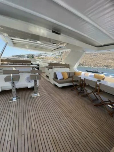a room with a wood floor and a large window with a view of the ocean aboard VIVERE Yacht for Sale