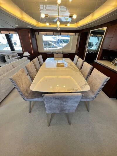 a room with a table and chairs aboard VIVERE Yacht for Sale