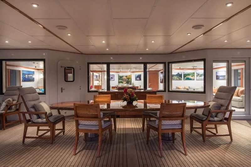 a room with a table chairs and a tv aboard NURJA Yacht for Sale