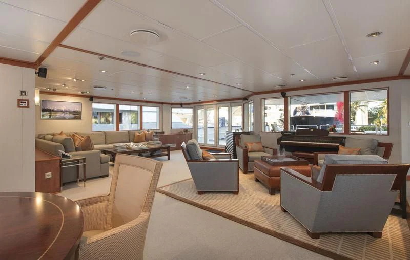a living room with a piano aboard NURJA Yacht for Sale