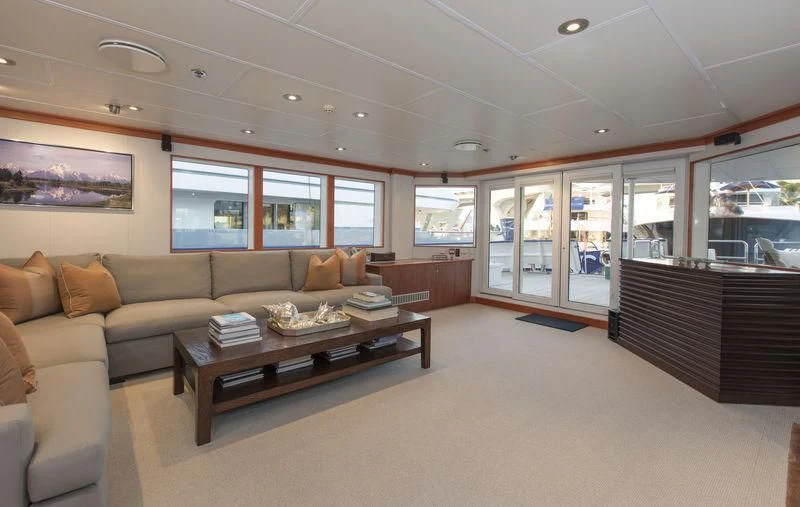 a living room with a couch and a coffee table aboard NURJA Yacht for Sale