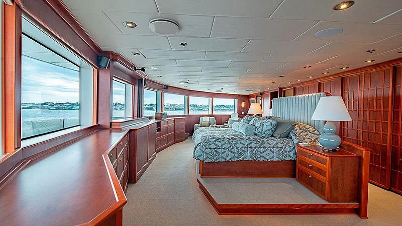a bedroom with a bed and a desk aboard NURJA Yacht for Sale