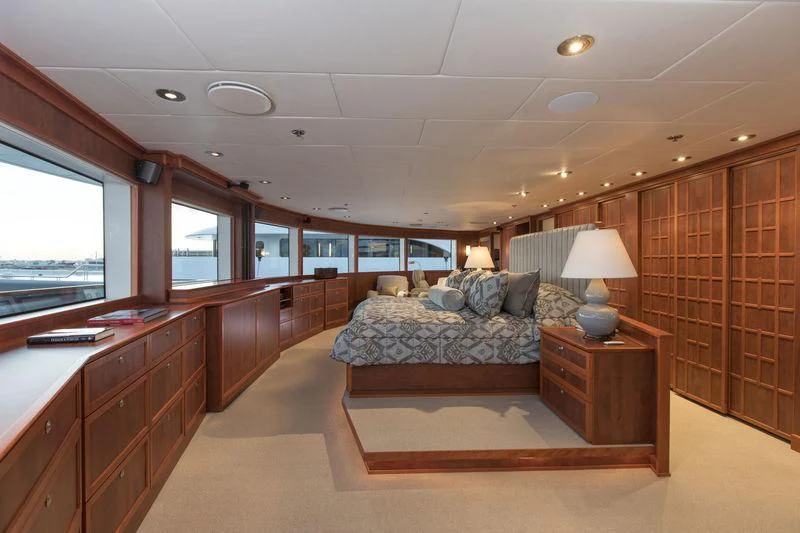 a bedroom with a bed and a desk aboard NURJA Yacht for Sale
