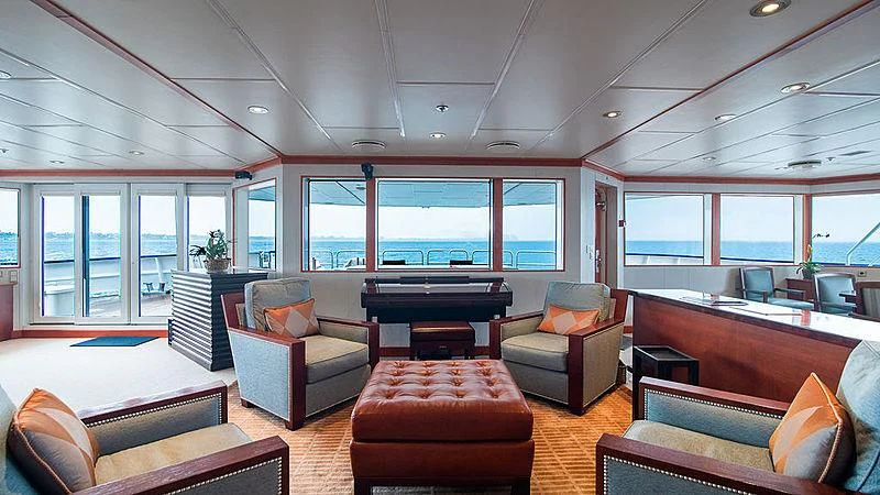 a large living room with a large window aboard NURJA Yacht for Sale