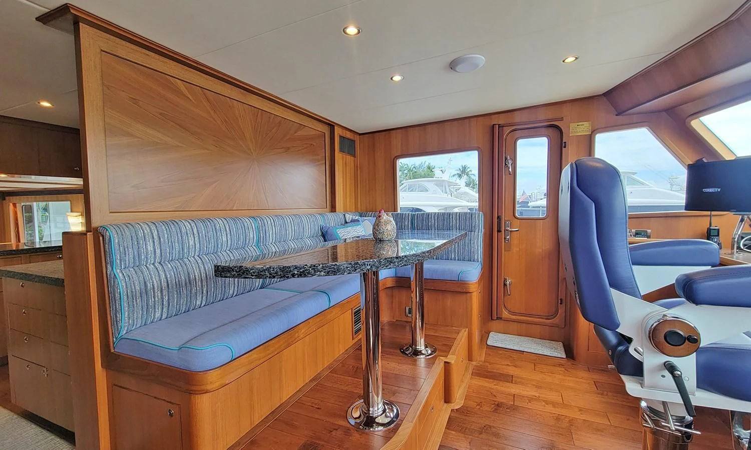 a room with a table and chairs aboard SUERTUDO Yacht for Sale