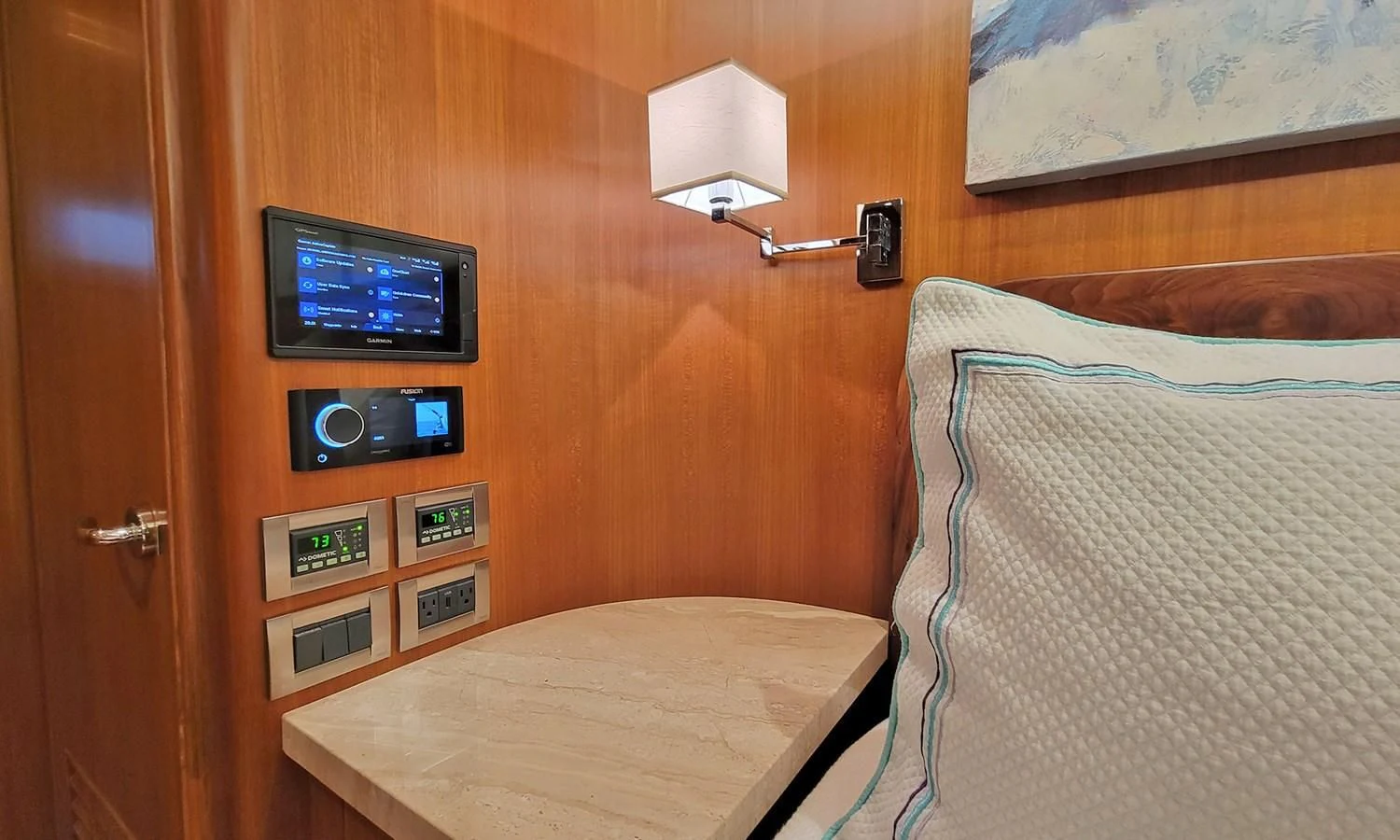 a bed with a television on the wall aboard SUERTUDO Yacht for Sale
