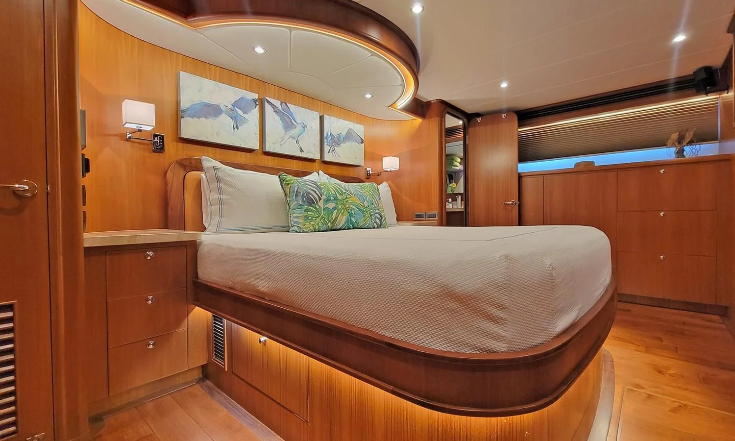 a bed with a wooden headboard aboard SUERTUDO Yacht for Sale