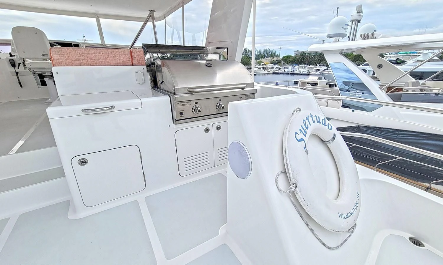 a white boat with a black seat aboard SUERTUDO Yacht for Sale
