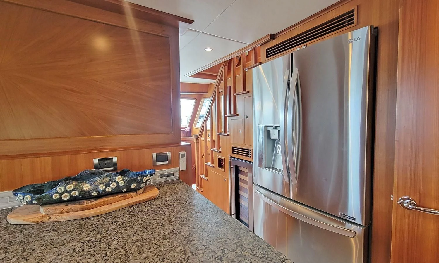 a kitchen with a large refrigerator aboard SUERTUDO Yacht for Sale