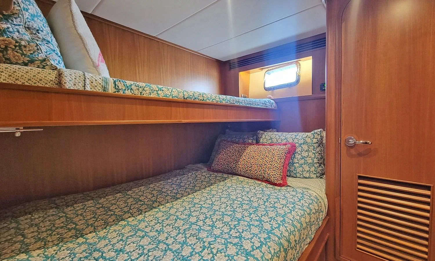 a bed with a blue comforter aboard SUERTUDO Yacht for Sale