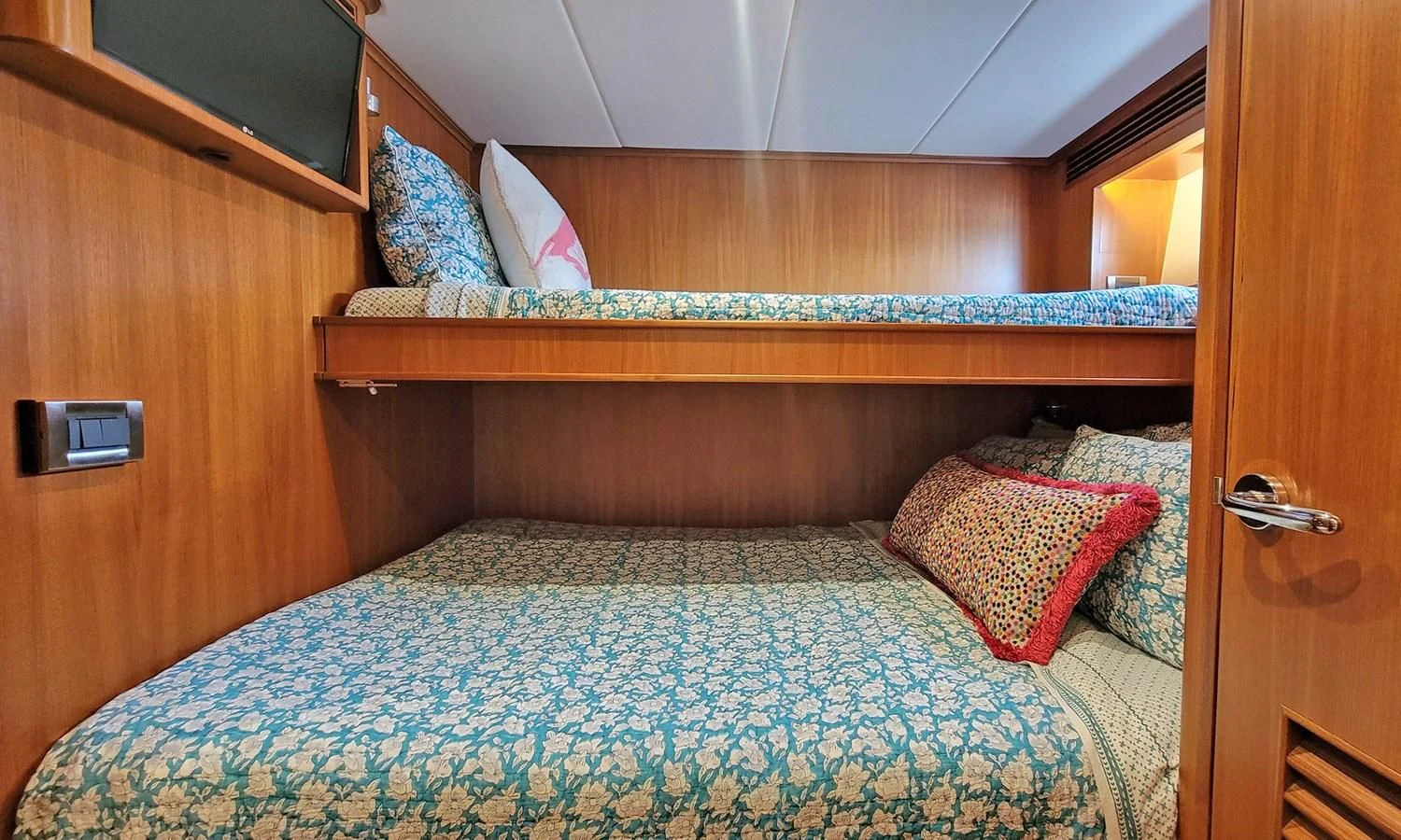 a bed with a blue comforter aboard SUERTUDO Yacht for Sale